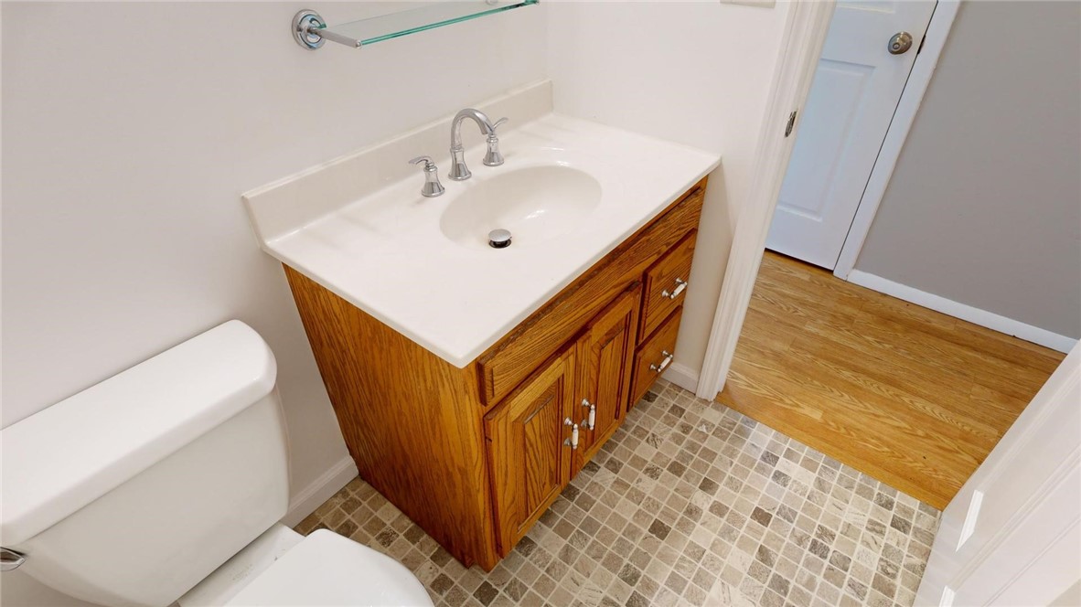 396 West Ash Avenue Decatur, IL 62526 - Photo 18 of 37 a bathroom with a sink a toilet and a mirror