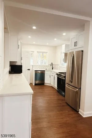 a kitchen with a refrigerator sink and stove top oven