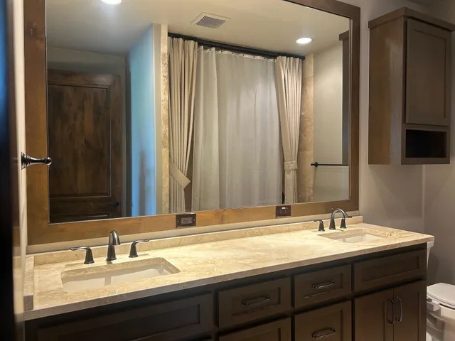 a view of an empty room with a cabinet and a flat screen tv