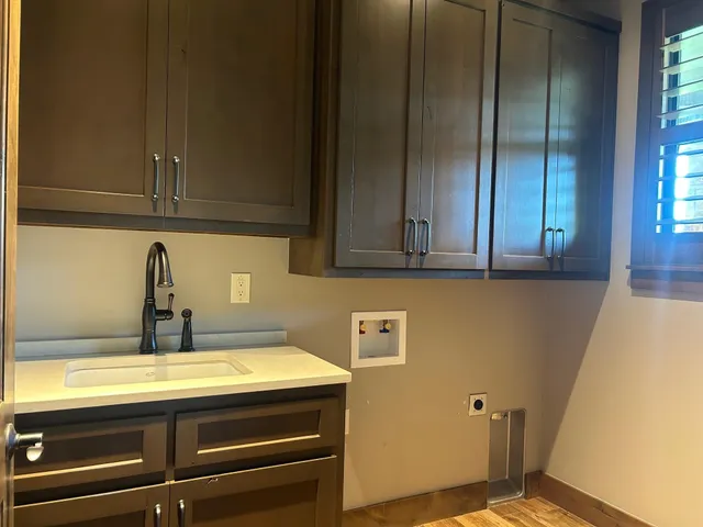 an empty room with a window and ceiling fan