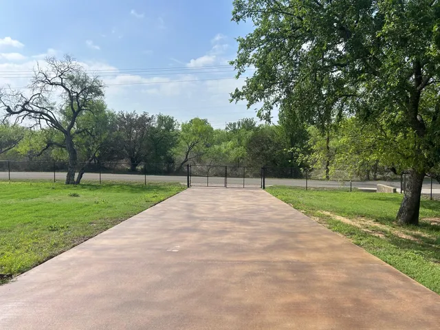 a view of a park with large trees