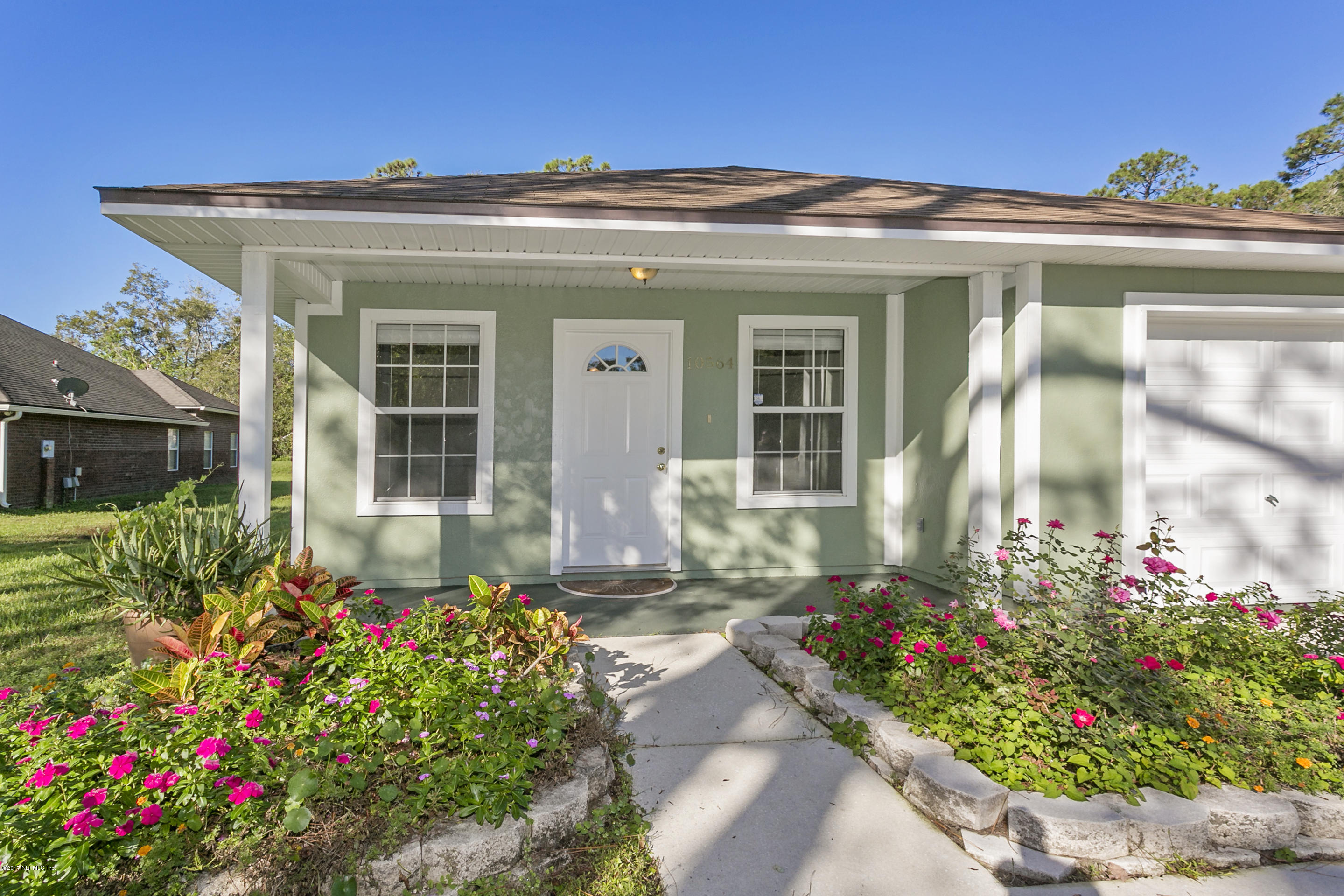 10564 Shamrock Road Jacksonville, FL 32256 - Photo 2 of 11 Covered Front Porch with Quaint Garden