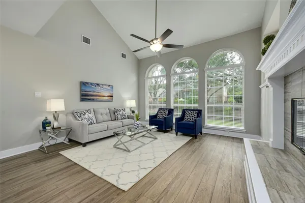 a living room with furniture and wooden floor