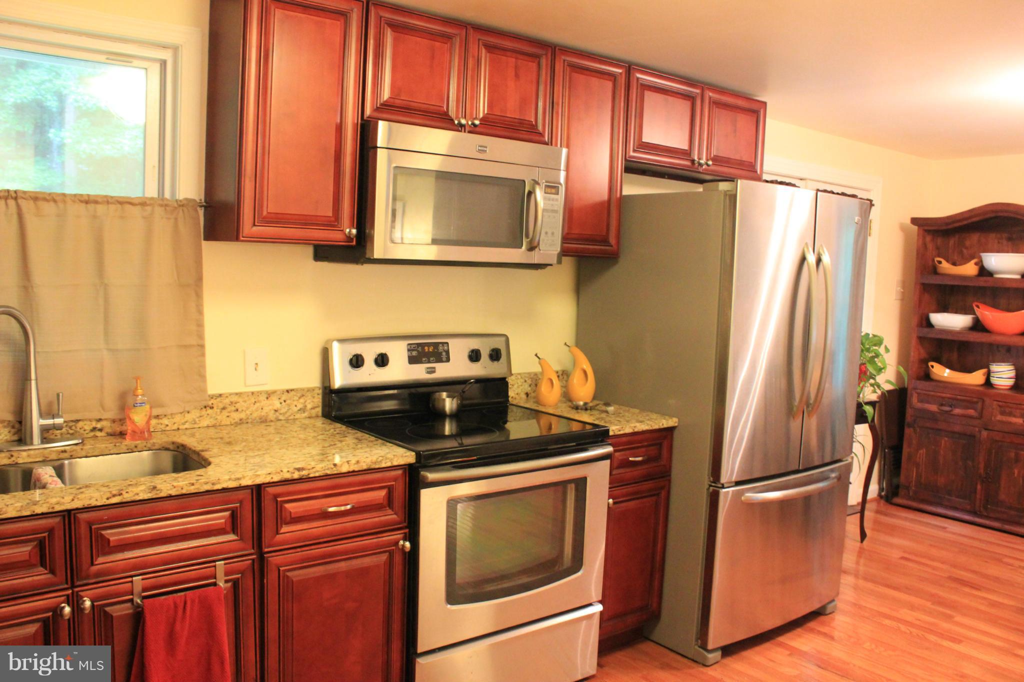 11602 Jester Way Dunkirk, MD 20754 - Photo 3 of 23 a kitchen with stainless steel appliances granite countertop a refrigerator stove and sink