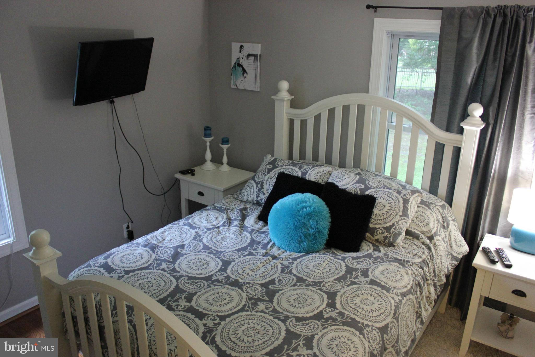 11602 Jester Way Dunkirk, MD 20754 - Photo 6 of 23 a bed sitting in a bedroom next to a window