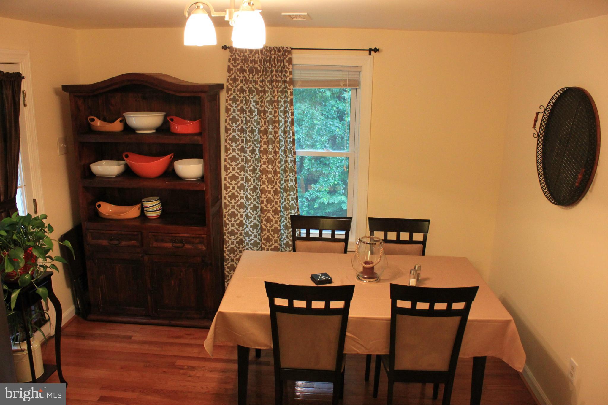11602 Jester Way Dunkirk, MD 20754 - Photo 8 of 23 a view of a dining room with furniture and wooden floor