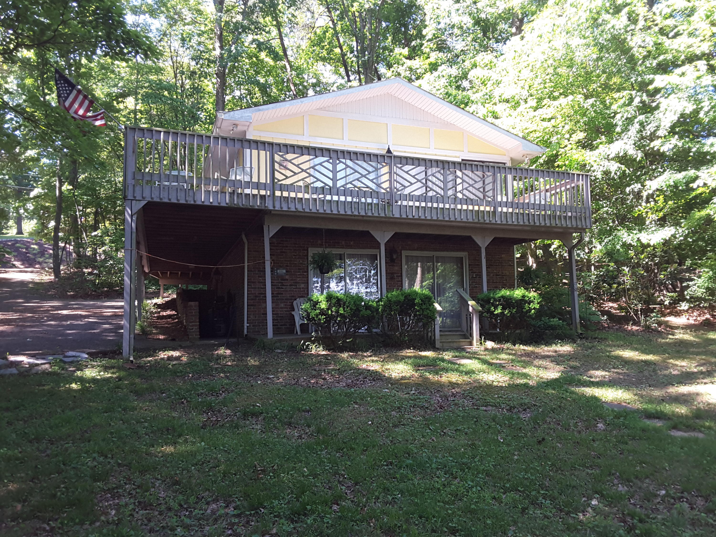 a view of a house with backyard porch and sitting area
