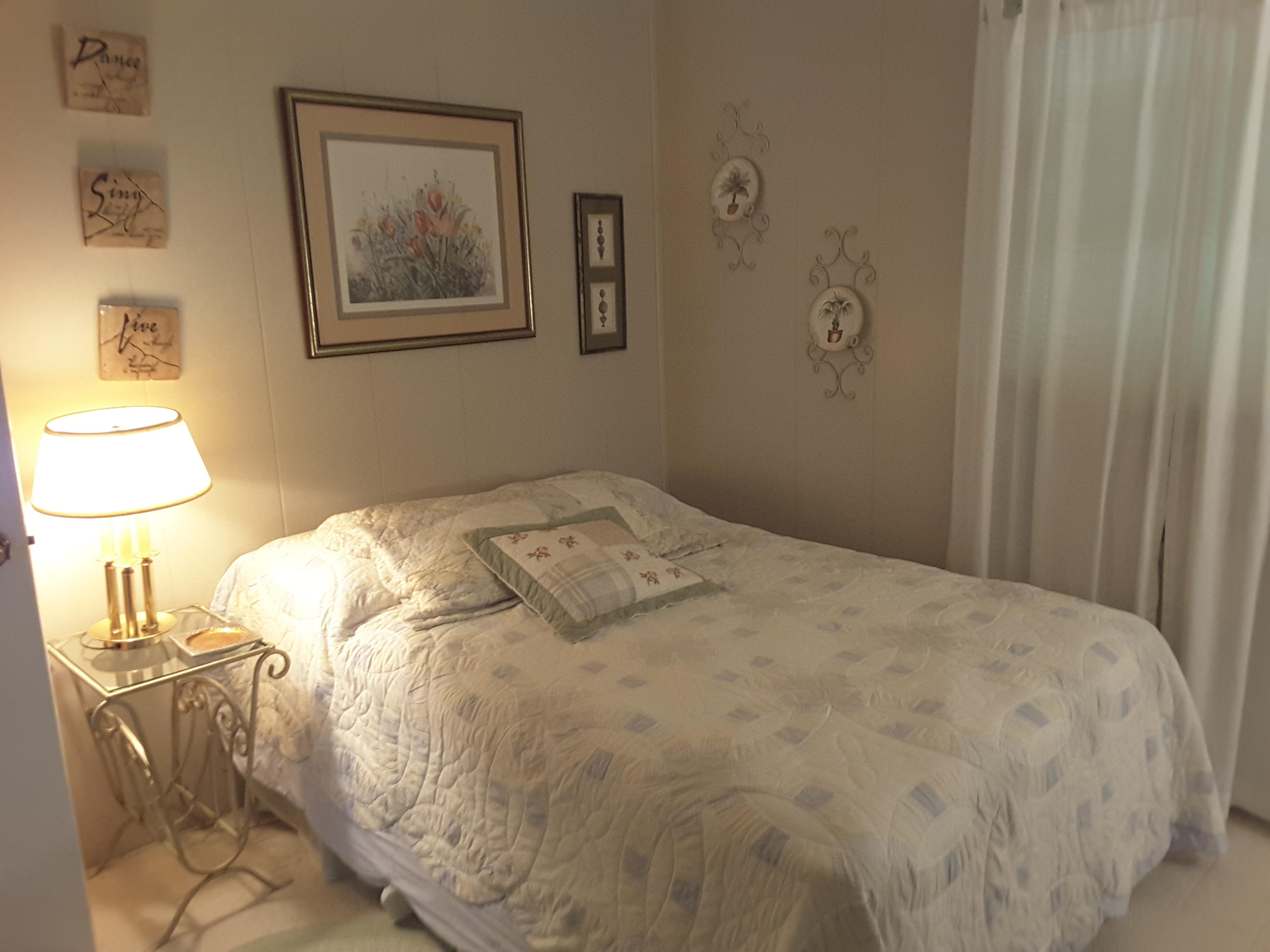 645 Highland Lake Road Union Hall, VA 24176 - Photo 8 of 14 a bedroom with a bed and a lamp on the dresser