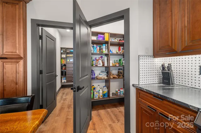 a room with furniture pool table and glass door