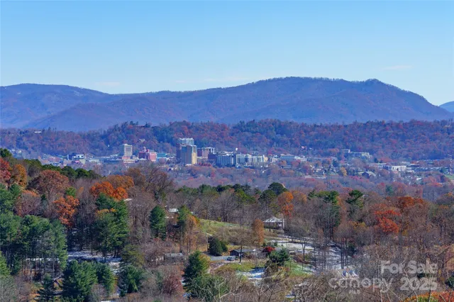 a view of a dining room and kitchen with furniture and a clock