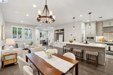 a large kitchen with a table and chairs