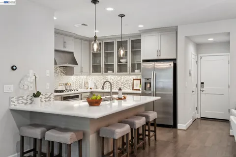 a kitchen with stainless steel appliances granite countertop a sink and a refrigerator