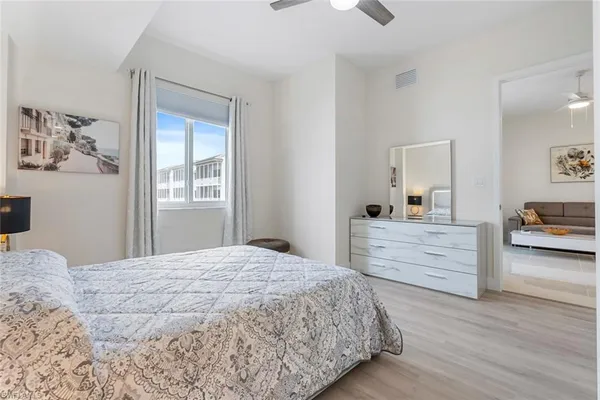 a room with a bed window and dresser