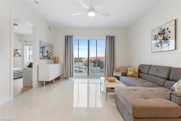a living room with furniture and a large window