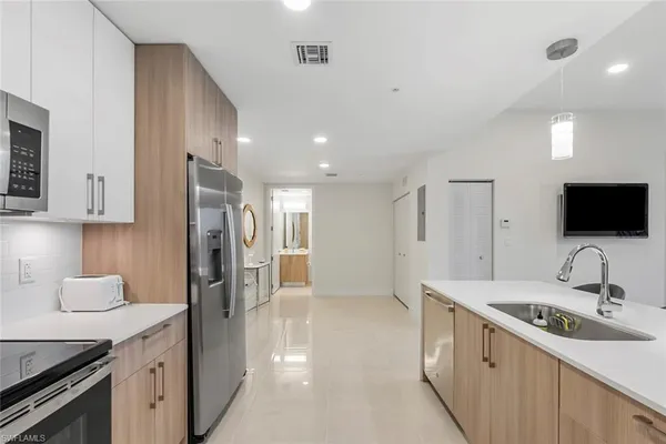 a kitchen with a sink stove and refrigerator