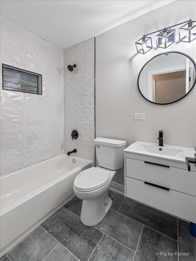 542 East Briarcliff Road Bolingbrook, IL 60440 - Photo 12 of 26 a white toilet sitting next to a bathroom sink and tub