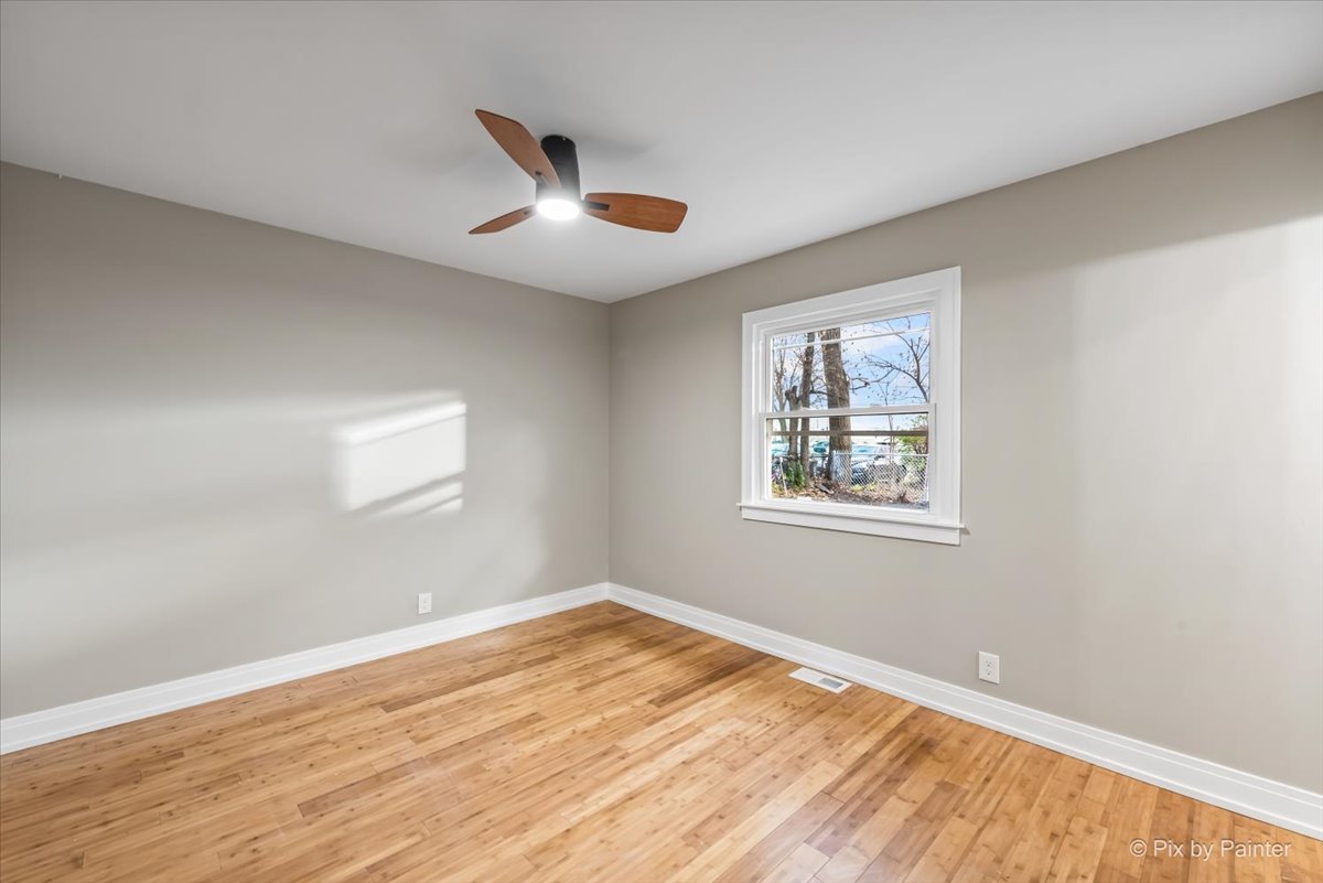 542 East Briarcliff Road Bolingbrook, IL 60440 - Photo 13 of 26 a view of an empty room with wooden floor and a window