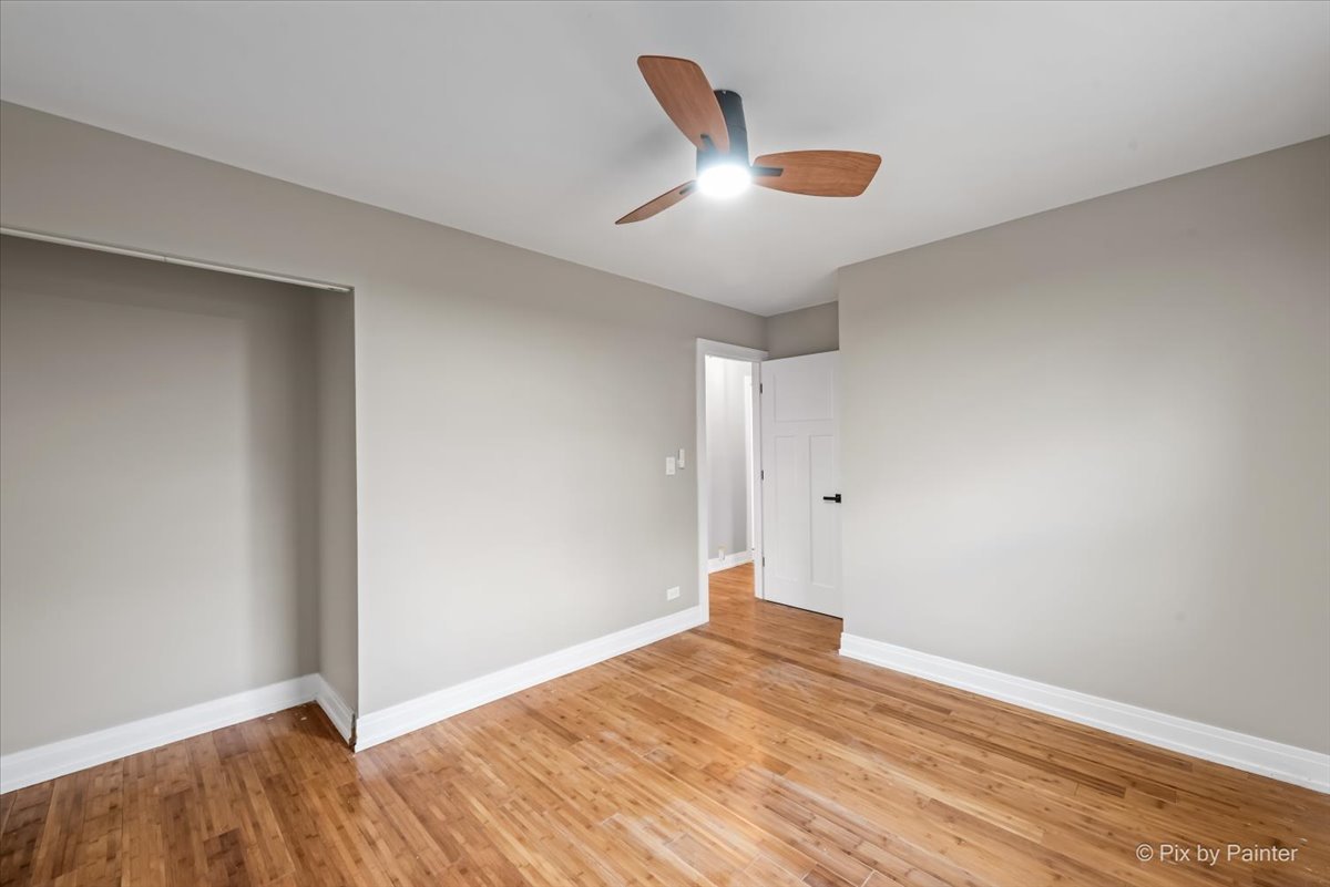 542 East Briarcliff Road Bolingbrook, IL 60440 - Photo 19 of 26 a view of an empty room with wooden floor and a window