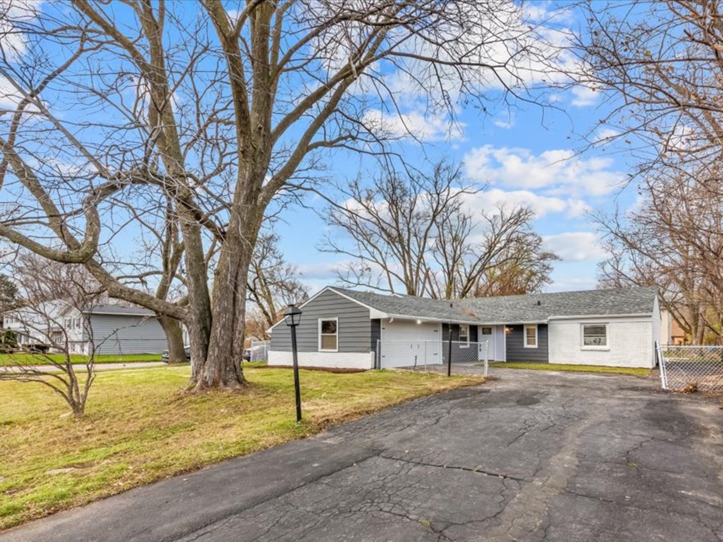 542 East Briarcliff Road Bolingbrook, IL 60440 - Photo 26 of 26 a view of a house with large trees and a yard