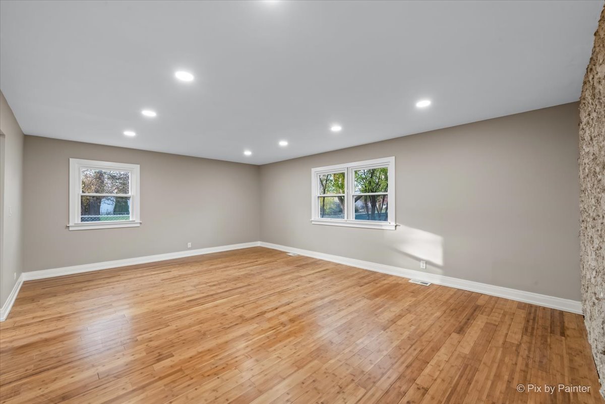 542 East Briarcliff Road Bolingbrook, IL 60440 - Photo 3 of 26 a view of empty room with wooden floor and fan