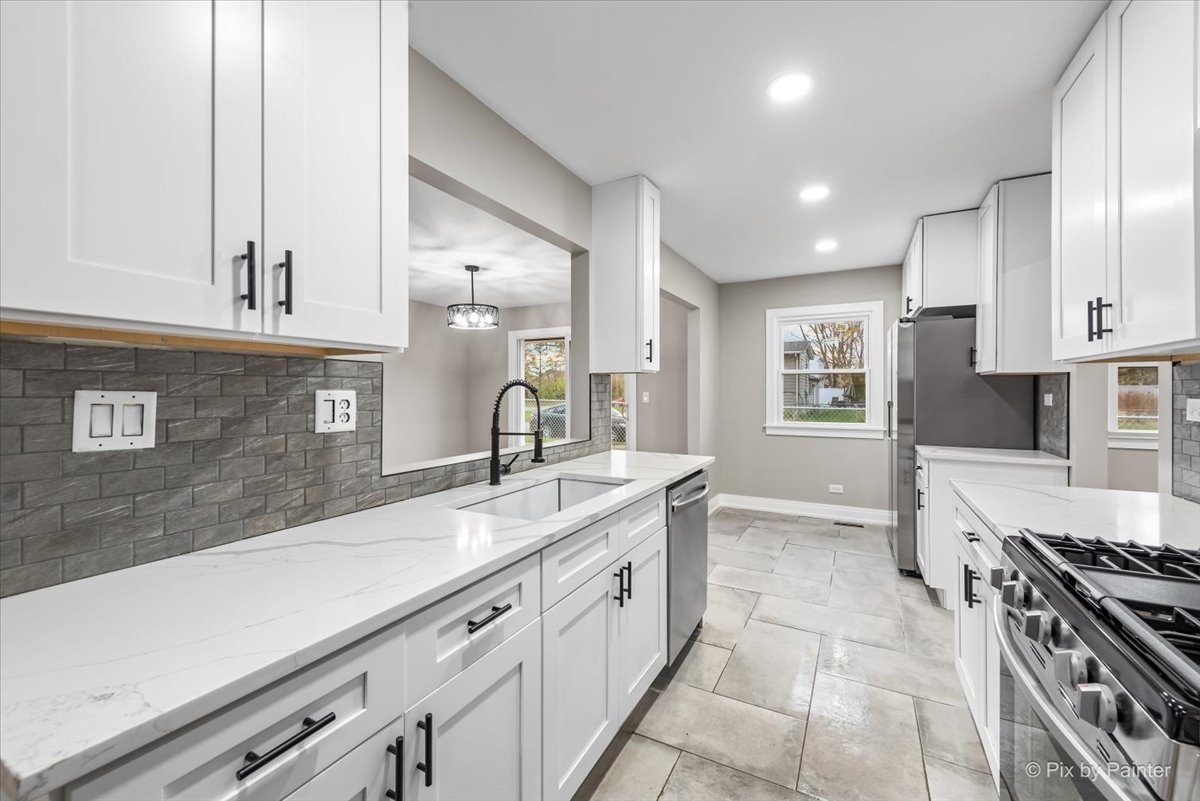 542 East Briarcliff Road Bolingbrook, IL 60440 - Photo 5 of 26 a kitchen with a sink stove top oven and cabinets