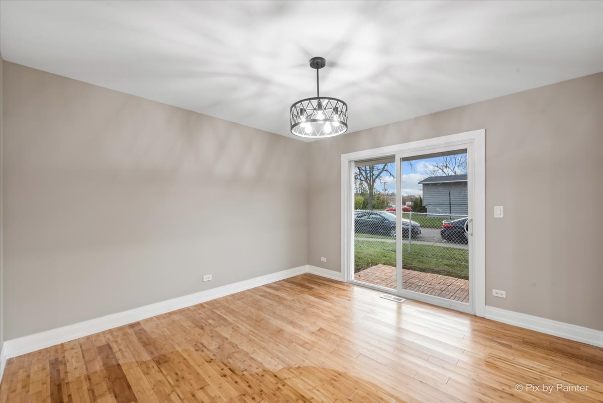 542 East Briarcliff Road Bolingbrook, IL 60440 - Photo 9 of 26 a view of an empty room with wooden floor and a window