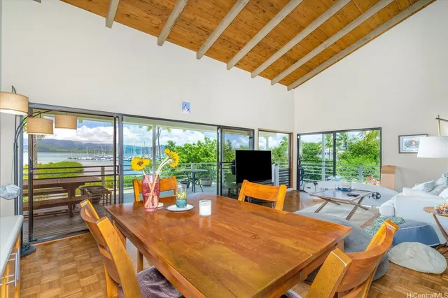 a dining room with furniture and a floor to ceiling window