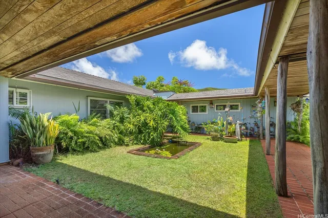 a view of a house with backyard and sitting area