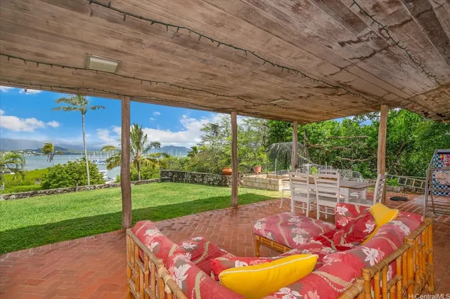 a view of a backyard with table and chairs under an umbrella
