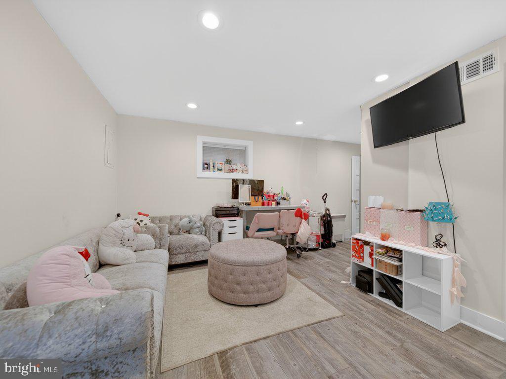 13427 Delaney Road Woodbridge, VA 22193 - Photo 50 of 57 a living room with furniture and a flat screen tv