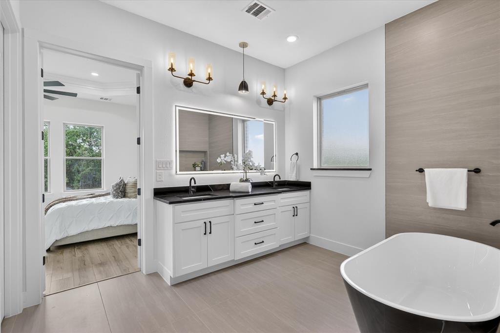 182 Briar Patch Azle, TX 76020 - Photo 19 of 36 Ensuite bathroom featuring double vanity and a soaking tub