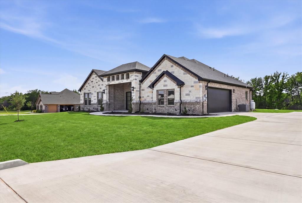 182 Briar Patch Azle, TX 76020 - Photo 2 of 36 View of front of home with a front yard, concrete driveway, a garage, and brick siding