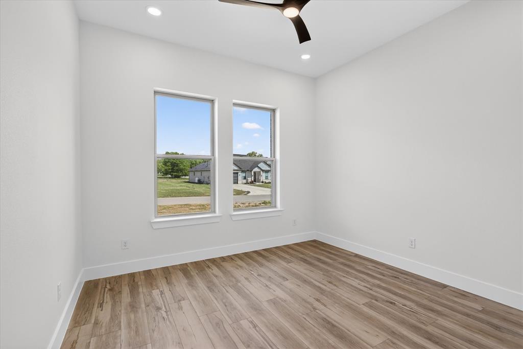 182 Briar Patch Azle, TX 76020 - Photo 29 of 36 Unfurnished room featuring light wood-type flooring, a ceiling fan, and recessed lighting