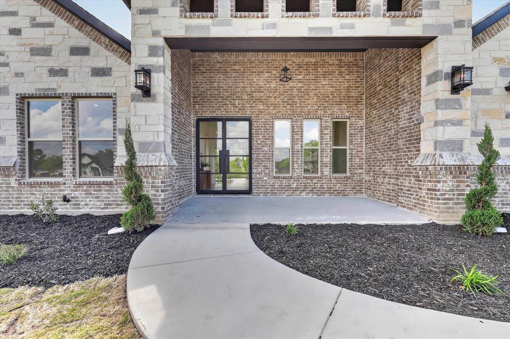 182 Briar Patch Azle, TX 76020 - Photo 31 of 36 Doorway to property with brick siding and a patio