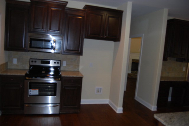 101 Laurel Ridge Forsyth, GA 31029 - Photo 4 of 21 a kitchen with granite countertop white cabinets and stainless steel appliances