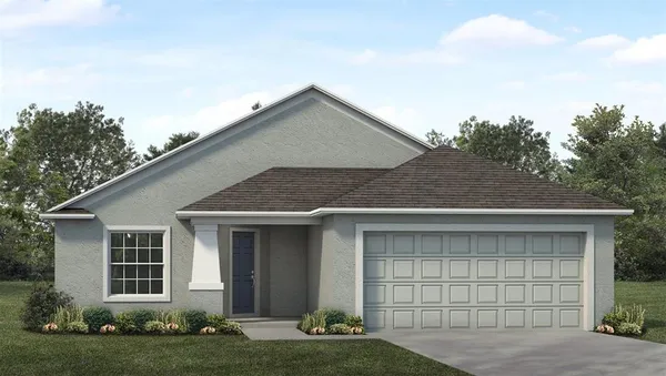 a front view of a house with a garden and yard