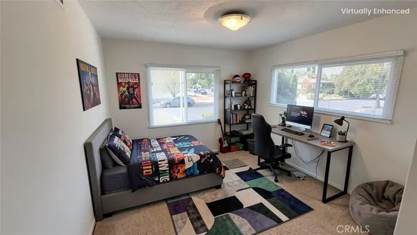 a living room with furniture a flat screen tv and a window