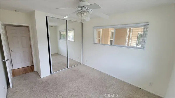 an empty room with windows and closet