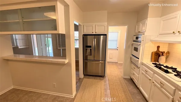 a kitchen with stainless steel appliances a refrigerator and a stove