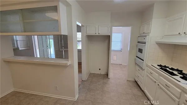 a kitchen with cabinets and appliances
