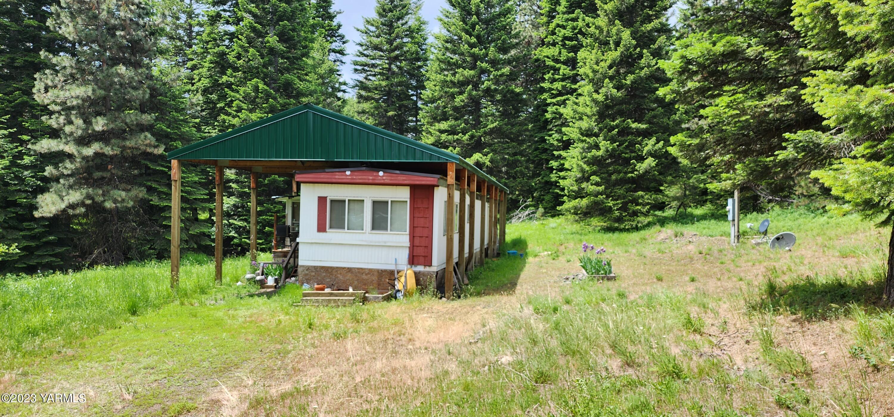 384 Cody Road Anatone, WA 99401 - Photo 1 of 33 a front view of a house with a yard