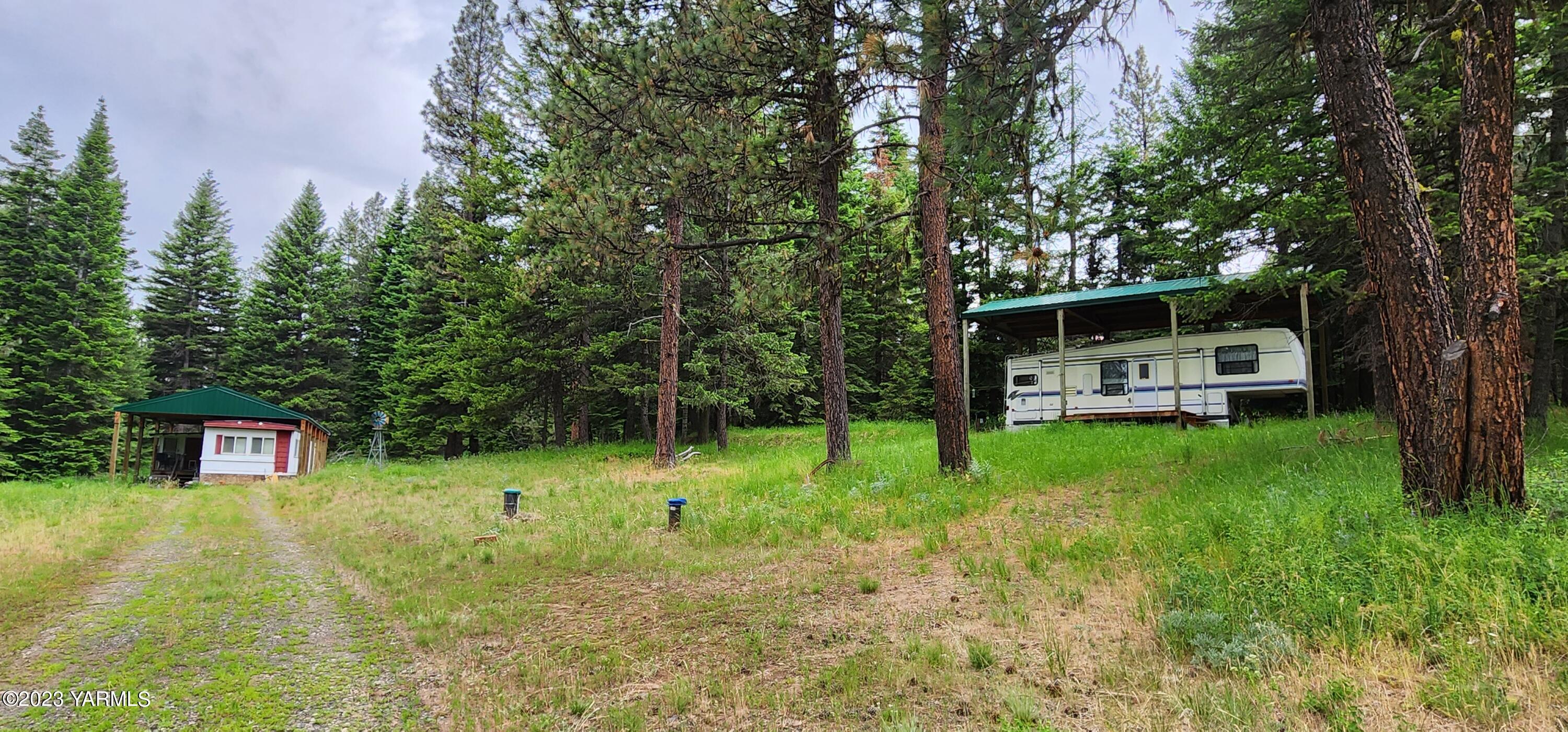 384 Cody Road Anatone, WA 99401 - Photo 2 of 33 a backyard of a house with table and chairs