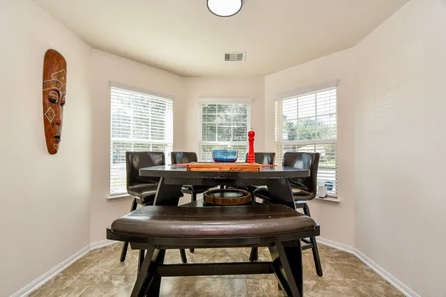 a view of a workspace with furniture and window
