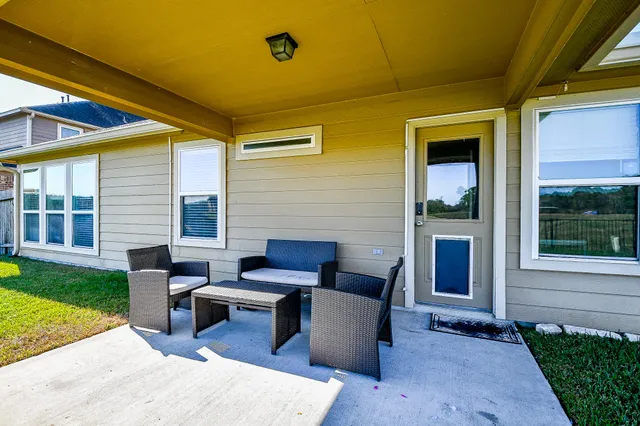 a view of a house with backyard and sitting area