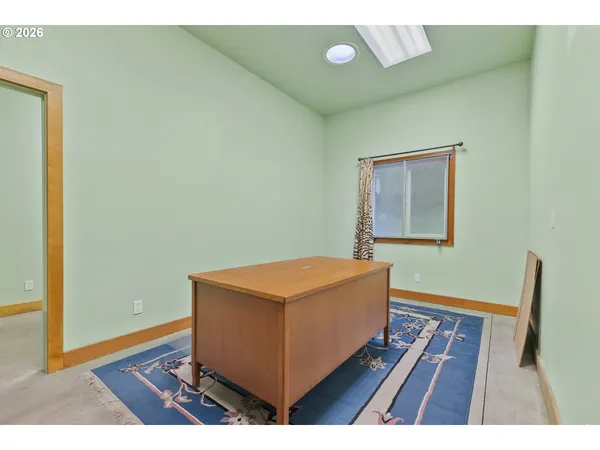 a view of a livingroom with furniture and a ceiling fan