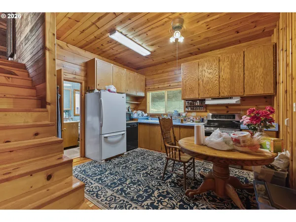 a kitchen with a refrigerator and a stove