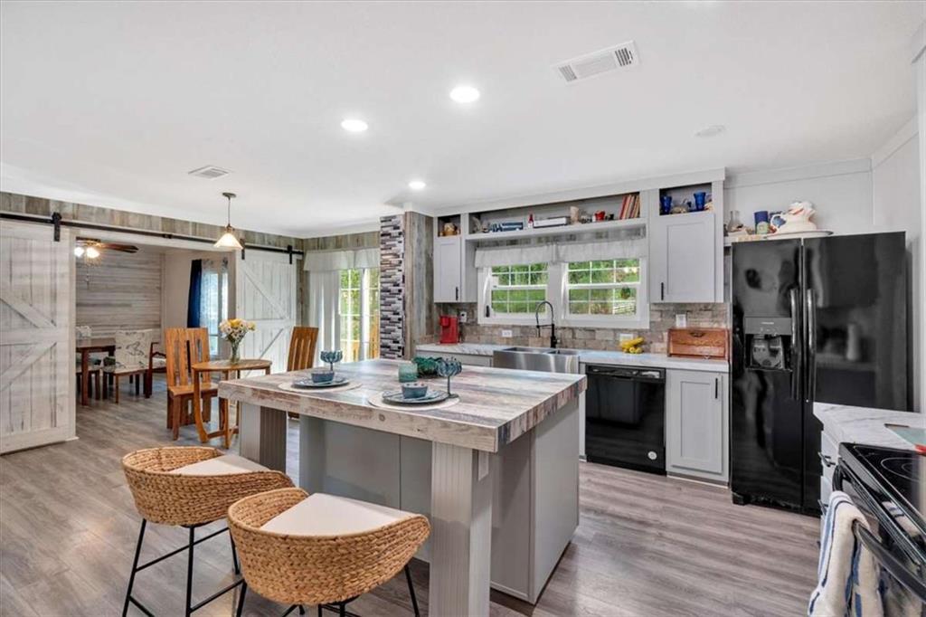 196 Whitestone Drive Talking Rock, GA 30175 - Photo 13 of 62 a kitchen with a refrigerator a stove a sink dishwasher with a dining table and chairs