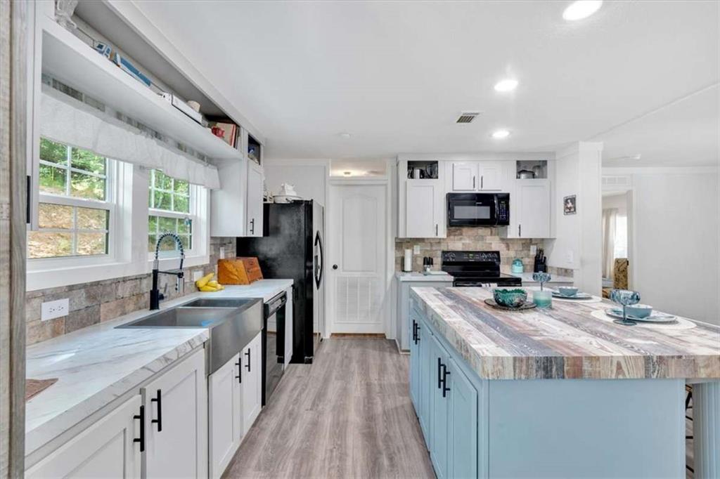 196 Whitestone Drive Talking Rock, GA 30175 - Photo 14 of 62 a kitchen with kitchen island granite countertop a sink appliances cabinets and a counter top space
