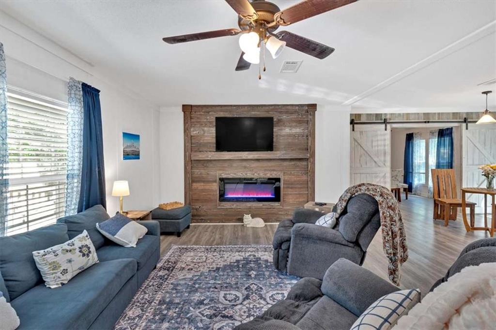 196 Whitestone Drive Talking Rock, GA 30175 - Photo 16 of 62 a living room with furniture a fireplace and a flat screen tv