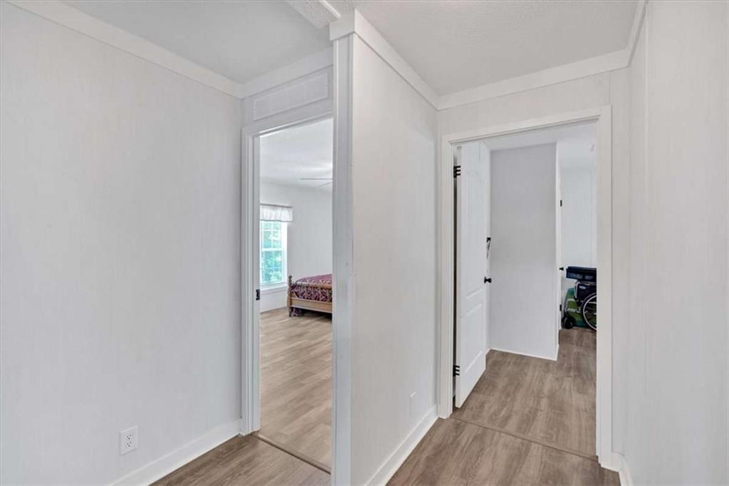 196 Whitestone Drive Talking Rock, GA 30175 - Photo 21 of 62 a view of a hallway with wooden floor and a bathroom